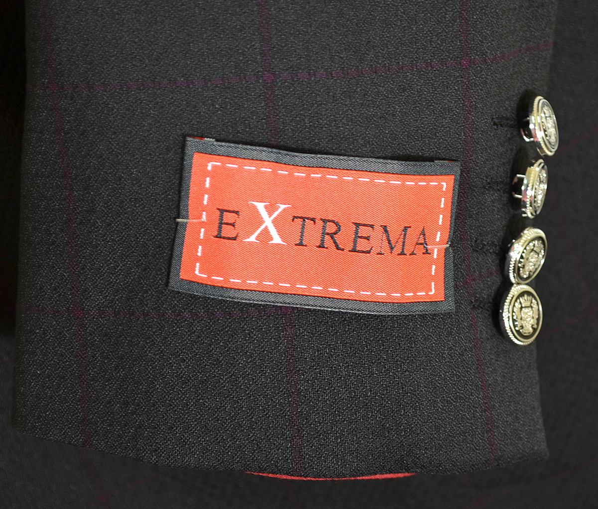extrema logo on a black suit